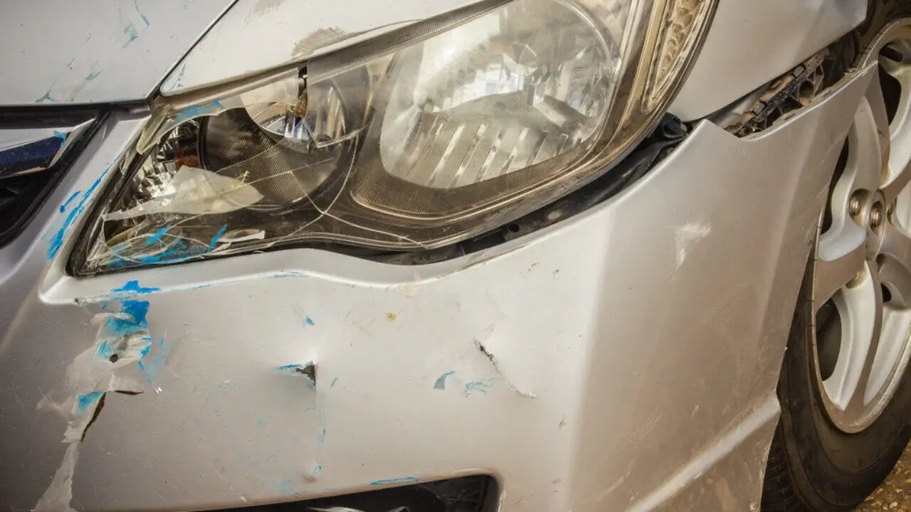 Damaged silver car front bumper