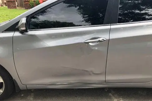 Damaged silver car door
