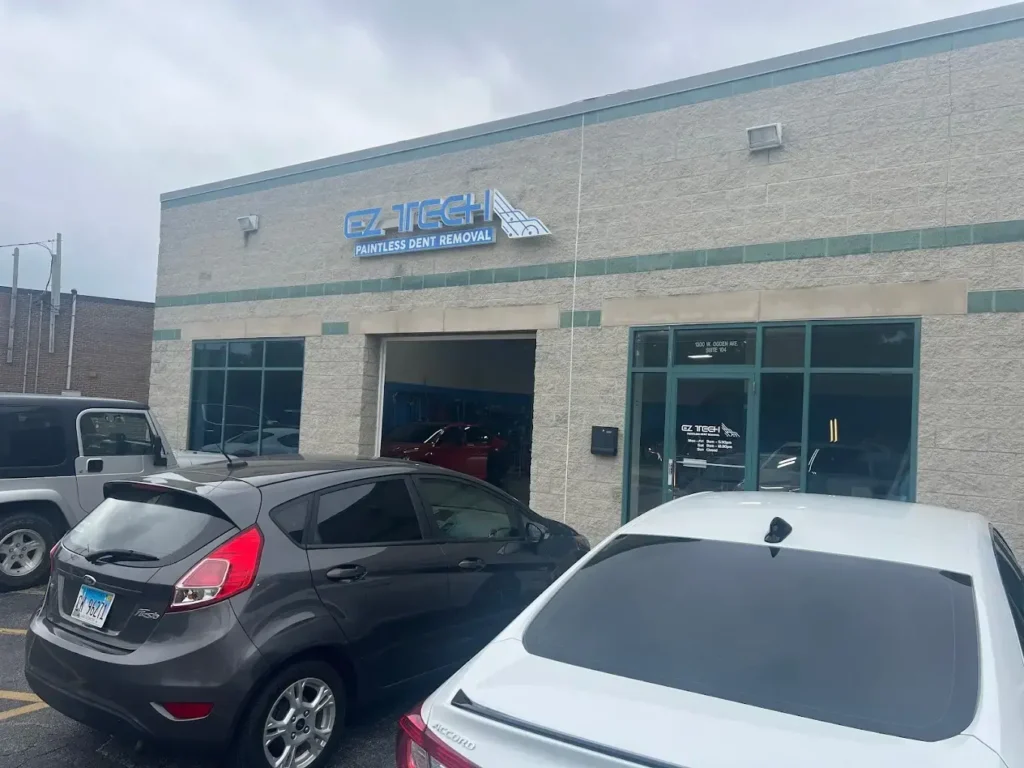Car repair shop exterior with vehicles
