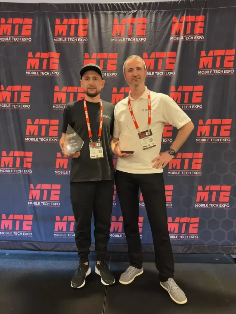 Two individuals at Mobile Tech Expo. Winner of the PDR contest at mobile tech 2026