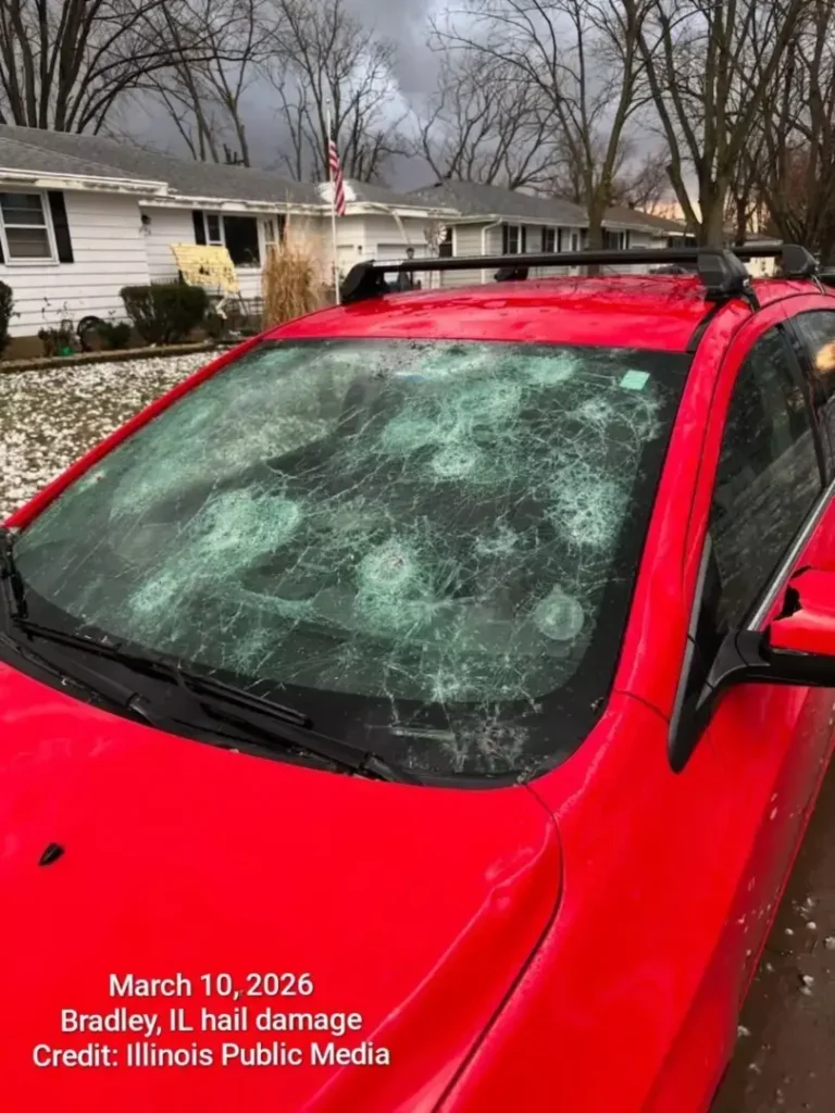 Red car with shattered windshield damage