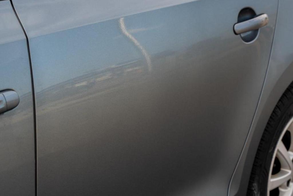 Car door with hail damage in Wheaton, IL, requiring Paintless Dent Removal repair.