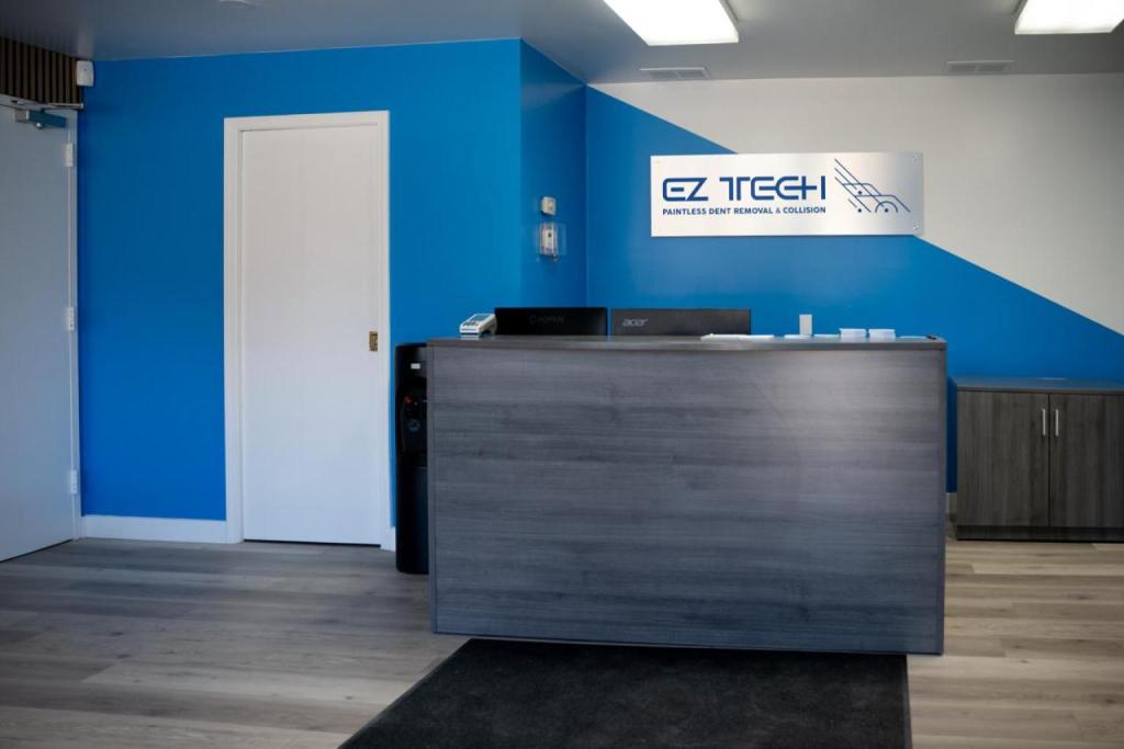 EZ Tech Paintless Dent Removal & Collision reception area with signage and service counter