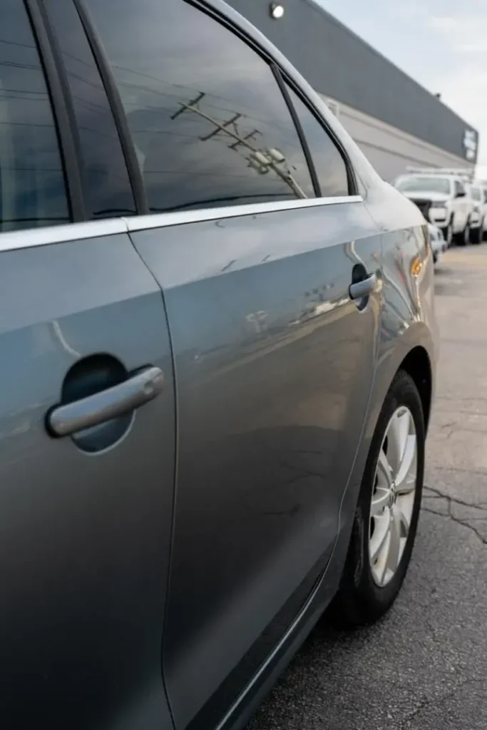 Gray sedan undergoing body panel replacement at Ez Tech collision repair.